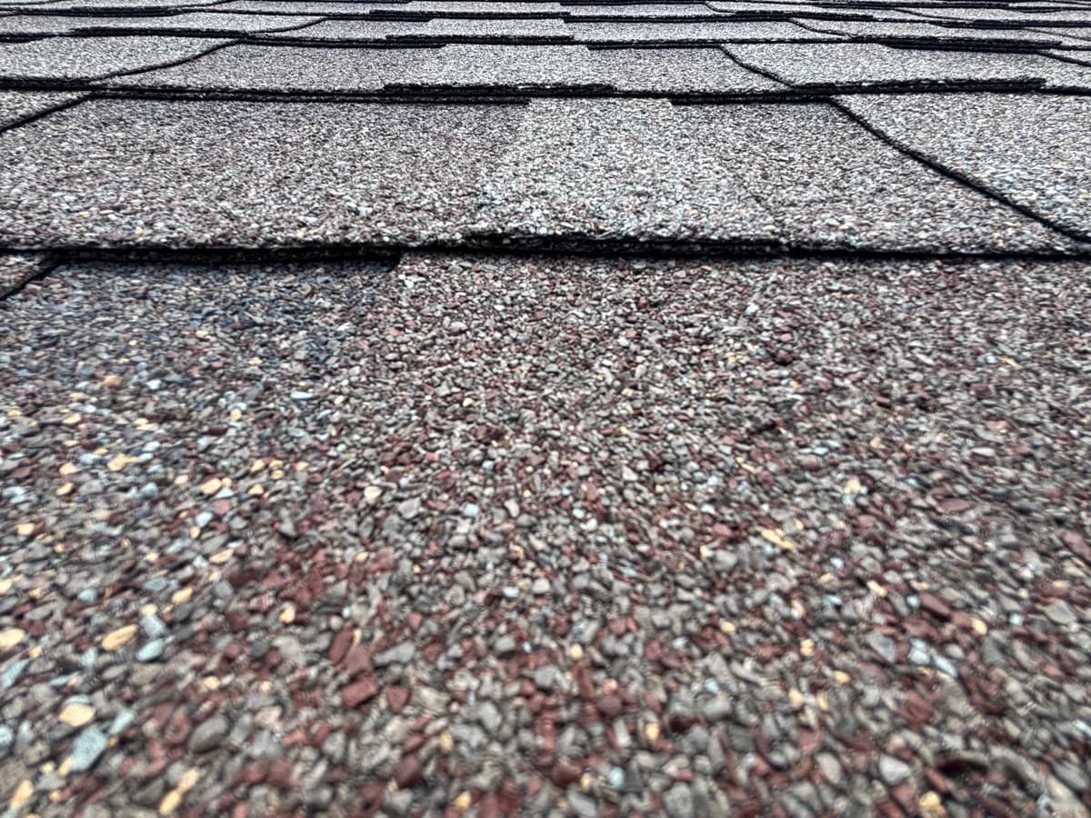 Close view of asphalt shingle texture and overlapping courses